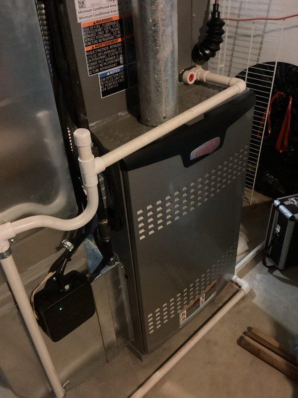 Performed routine tune-up service on a 2-year-old furnace system. Inspected air filter housing and confirmed filter is clean and properly installed. Examined furnace unit with PVC venting system, verified all connections are secure, and confirmed system operation is within normal parameters.