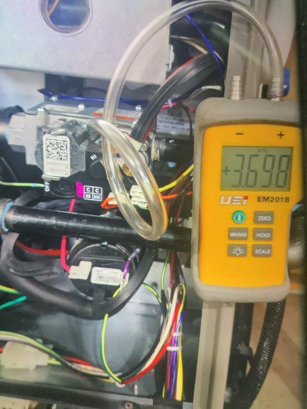 Performed MVP heating maintenance service with comprehensive system diagnostics. Conducted static pressure measurements using UEi EM201B device (reading 36.98), and inspected evaporator coils which showed normal frost pattern with minor dust accumulation. System connections and wiring were verified intact with no issues detected.