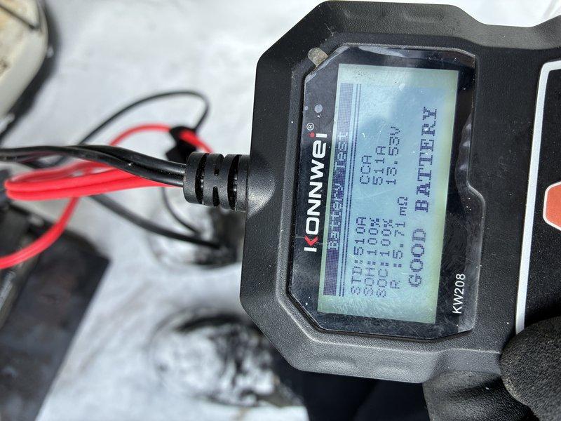 Performed diagnostic service on 31-year-old Generac residential backup generator. Battery tested using Konnwei KW208 diagnostic tool, which indicated "GOOD BATTERY" status with acceptable CCA and SOC values. Inspected unit exterior and connections, noting snow accumulation but no visible external damage. Generator failed initial inspection with red indicator light active; completed necessary adjustments and testing to restore proper functionality.
