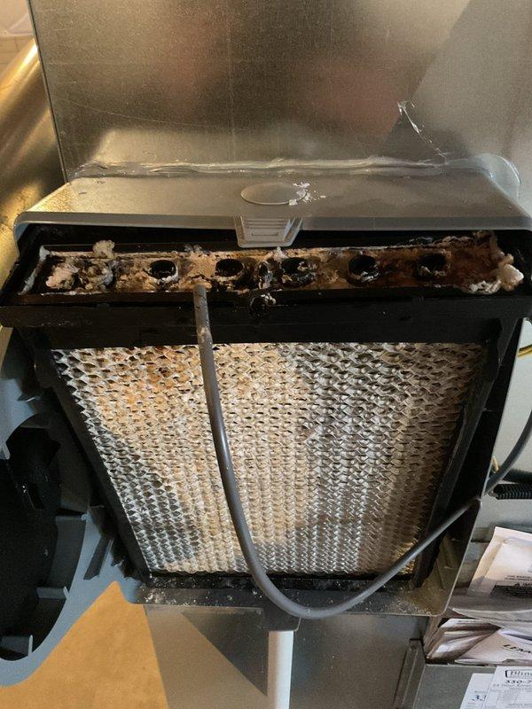 Performed scheduled MVP Heating maintenance service. Inspection revealed severely soiled filter with significant dust accumulation and heavily contaminated evaporator coil/air handler unit showing brownish-black debris buildup. Recommended immediate replacement of filter and professional cleaning of coil assembly to restore proper system efficiency and prevent potential airflow restrictions.
