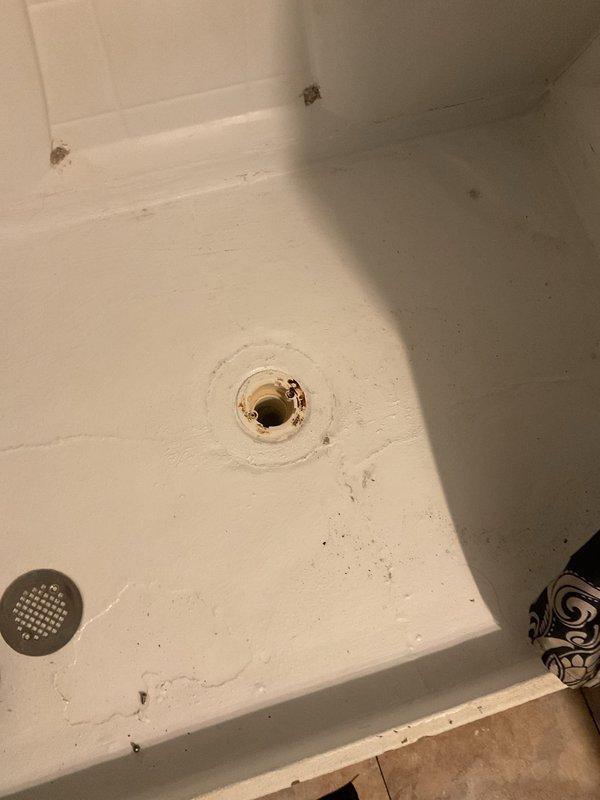 Responded to service call for multiple clogged upstairs drains in century-old home. Upon inspection, discovered deteriorated drain system with significant corrosion in bathtub drain and compromised pipe connections in ceiling infrastructure. Successfully cleared blockage and advised homeowner on recommended repairs to address visible water damage and aging plumbing components.