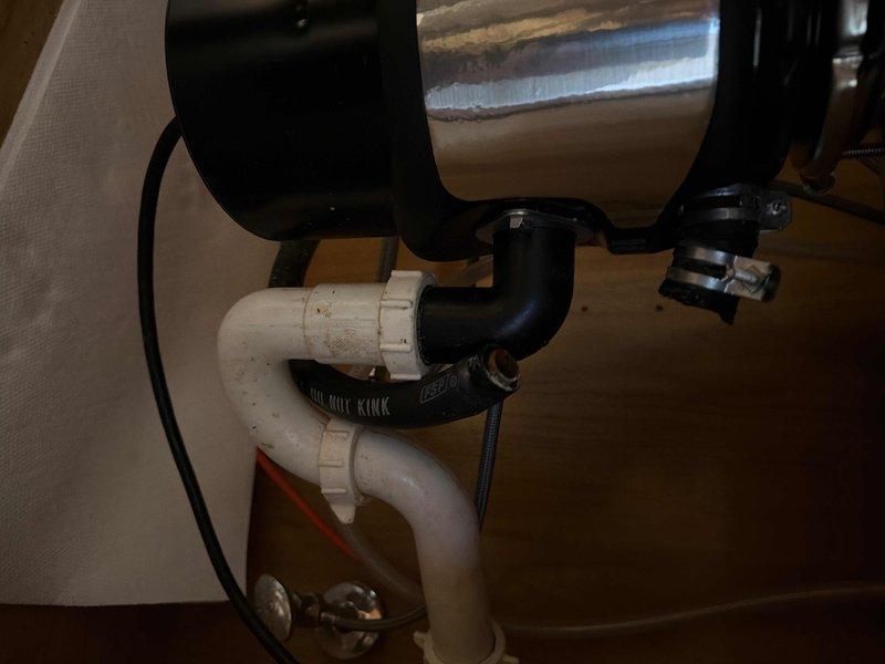 Responded to a customer complaint regarding water leak beneath kitchen sink. Upon inspection, identified the source of the leak at the dishwasher connection point. Tightened the loose fittings on the drain assembly and verified the disposal was properly sealed. Tested water flow and confirmed resolution with no further leakage present.