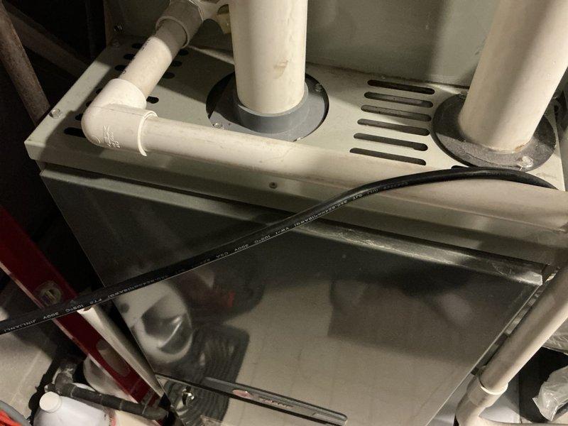 Performed diagnostic inspection of 13-year-old furnace, confirming cracked heat exchanger and failure of second-stage operation. Documented existing HVAC system components and plumbing configuration. Provided replacement estimate for new unit with Lord rebate eligibility.