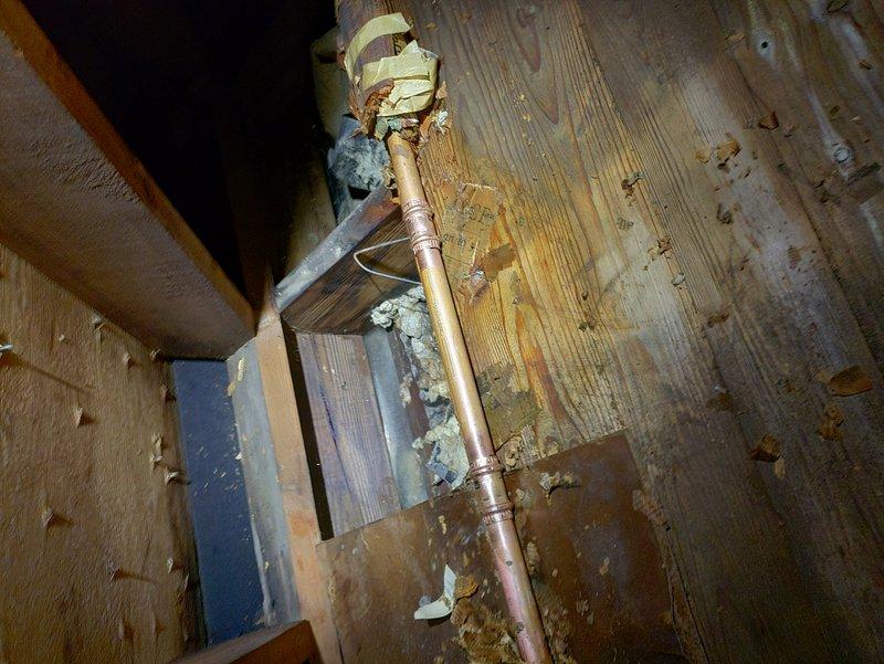 Successfully repaired copper pipe that had burst by replacing the damaged section and installing new pipe between wooden joists. System was pressure tested after repair to confirm integrity of the new installation and proper function of the heating system's expansion tank and control valves.