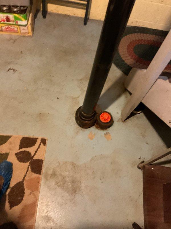 Responded to MVP NAT customer report of basement drain clog. Inspected the basement utility area, which included a vertical waste pipe with brass fitting and nearby expansion tank system. No active intervention was required as inspection revealed normal system operation with no current blockage.