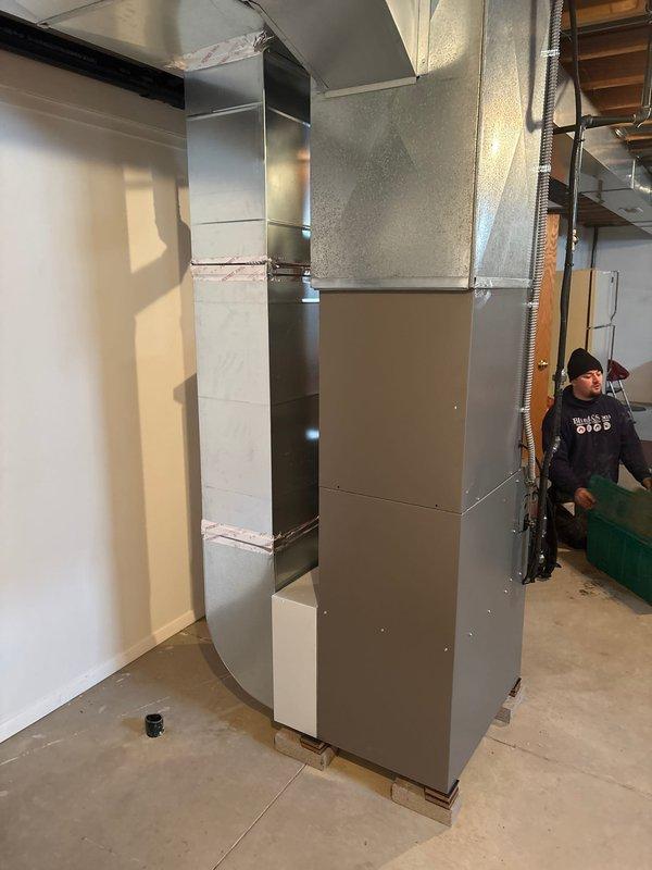 Successfully installed a complete 80% furnace and air conditioning system. Installation included proper gas line configuration with shutoff valve and flexible connection to the furnace. Mounted air handler unit with appropriate ductwork connections in the utility area.