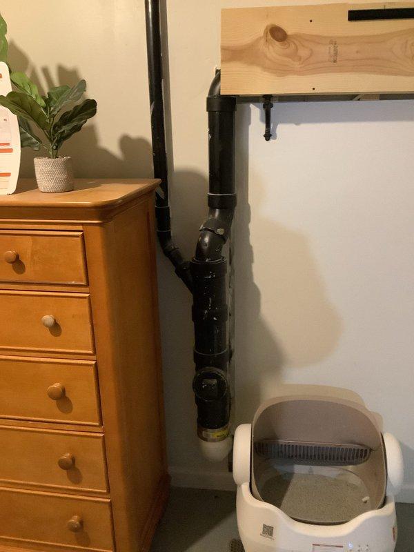 Responded to service call regarding multiple toilets experiencing drainage, filling issues, and bubbling. Inspected plumbing system and located black PVC drainage pipe with connection joints in utility area. Resolved drainage problems by clearing blockage in main waste line, restoring normal toilet operation throughout residence.