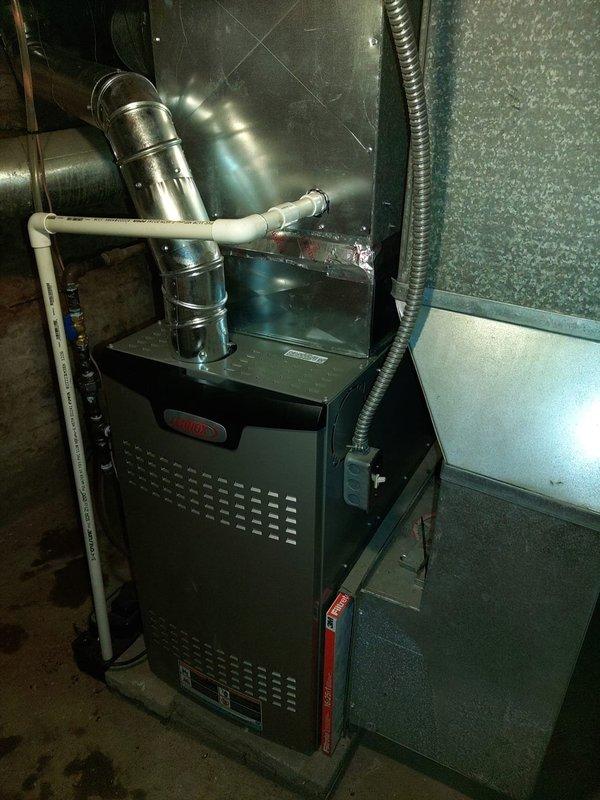 Successfully installed a new 80% efficiency Lennox furnace with complete ductwork connection in basement utility area. System includes an integrated UV lamp for improved air quality. All connections properly secured and system tested for optimal performance.