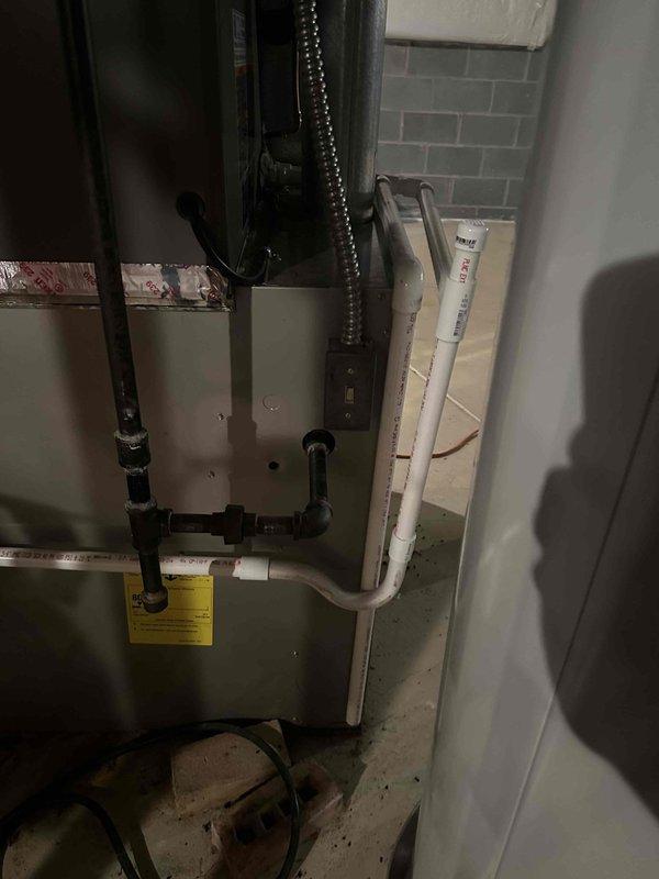 Completed Carrier HVAC system installation with furnace and ductwork in utility area. Secondary auxiliary drain for indoor A-coil was identified as missing during inspection. Installation requires manager approval and re-inspection with photographic documentation to be submitted to county inspector.