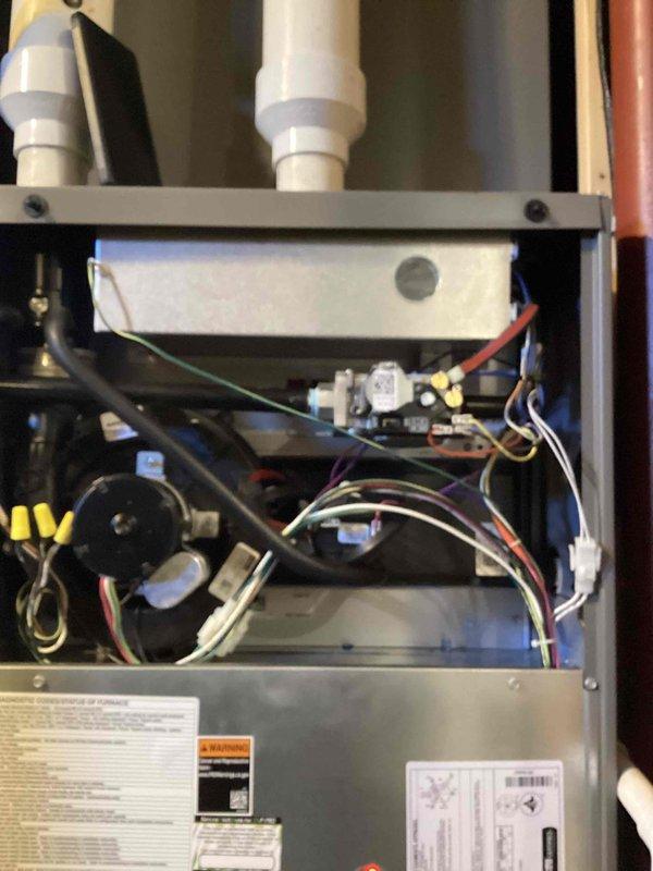 Performed comprehensive tune-up on 4-year-old furnace. Inspected internal electrical components including control board, wiring connections, and transformer. Examined ventilation system including PVC pipes and metal ductwork in basement utility area. All systems functioning properly after service.