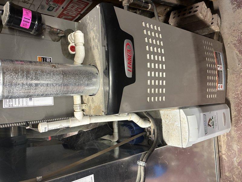 Performed annual maintenance on 5-year-old Lennox furnace. Inspected gas valve operation and confirmed proper positioning (open). Noted cobwebs around valve assembly and plumbing components. System appears to be functioning normally with all connections secure.