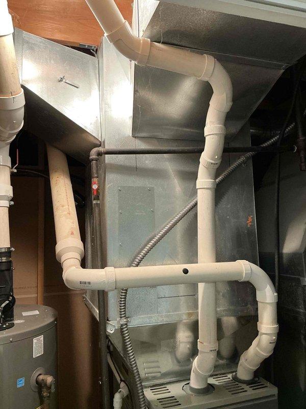 Performed diagnostic assessment on 2012 Trane furnace with cracked heat exchanger. System currently operational but requires replacement due to safety concerns. Documented existing installation configuration including ductwork, ventilation components, and electrical connections to prepare comprehensive replacement estimate.