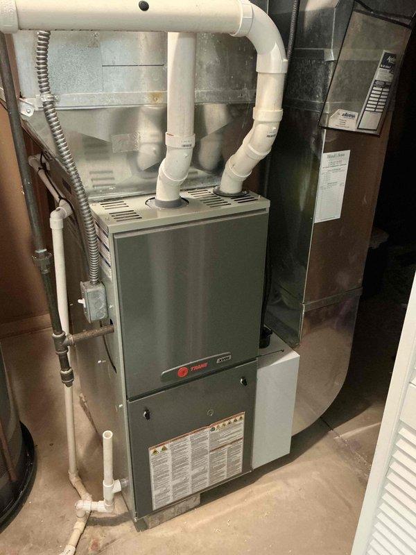 Performed diagnostic assessment on 2012 Trane furnace with cracked heat exchanger. System currently operational but requires replacement due to safety concerns. Documented existing installation configuration including ductwork, ventilation components, and electrical connections to prepare comprehensive replacement estimate.