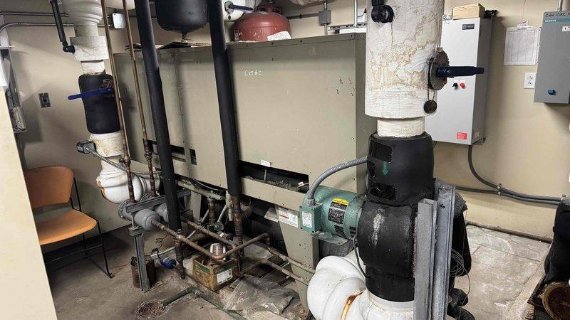 Diagnosed 20+ year old natural gas boiler system serving a 4-story commercial building with no heat complaint. Inspection revealed issues with the control center and electrical components. Examined the complex wiring connections in the electrical control panel and evaluated the boiler assembly, pumps, and associated piping infrastructure. Determined necessary repairs to restore heating functionality to the building's delta heating system.