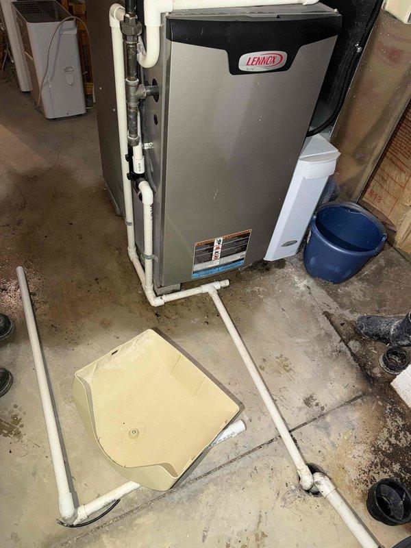 Responded to service call for water leak from broken humidifier feed line. Discovered corroded copper supply pipe connection to humidifier with significant oxidation at brass valve junction. Replaced damaged black supply tube and repaired copper pipe connection to eliminate leak source. Also addressed abnormal furnace noise during diagnostic inspection of Lennox heating system.
