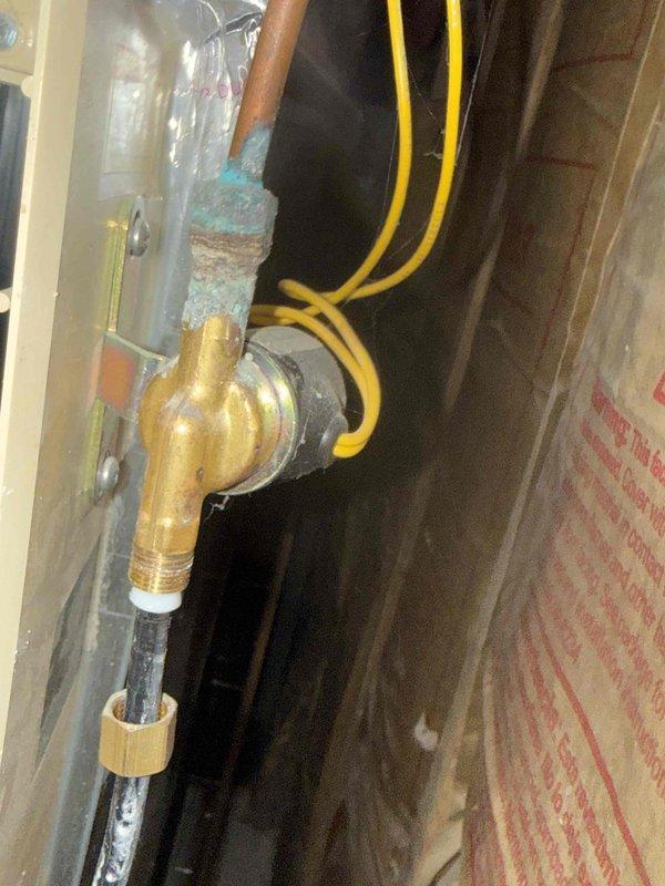 Responded to service call for water leak from broken humidifier feed line. Discovered corroded copper supply pipe connection to humidifier with significant oxidation at brass valve junction. Replaced damaged black supply tube and repaired copper pipe connection to eliminate leak source. Also addressed abnormal furnace noise during diagnostic inspection of Lennox heating system.