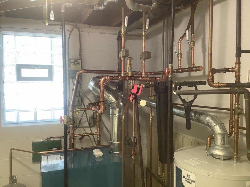 Successfully completed installation of a new boiler system with comprehensive copper piping network. Installed a Bradford White water heater alongside the primary boiler unit, ensuring proper connection of all valves, joints, and fittings. Mounted control box with multiple ports and installed circulation pump with pressure gauge for optimal system performance.