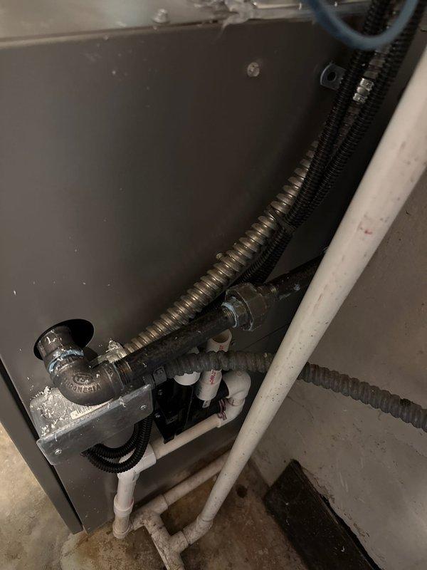 Completed installation of a 90% efficient furnace with humidifier. Properly installed condensate drainage system with P-trap assembly connected to PVC piping. Performed electrical testing with digital meter showing -356 reading to verify proper system function.