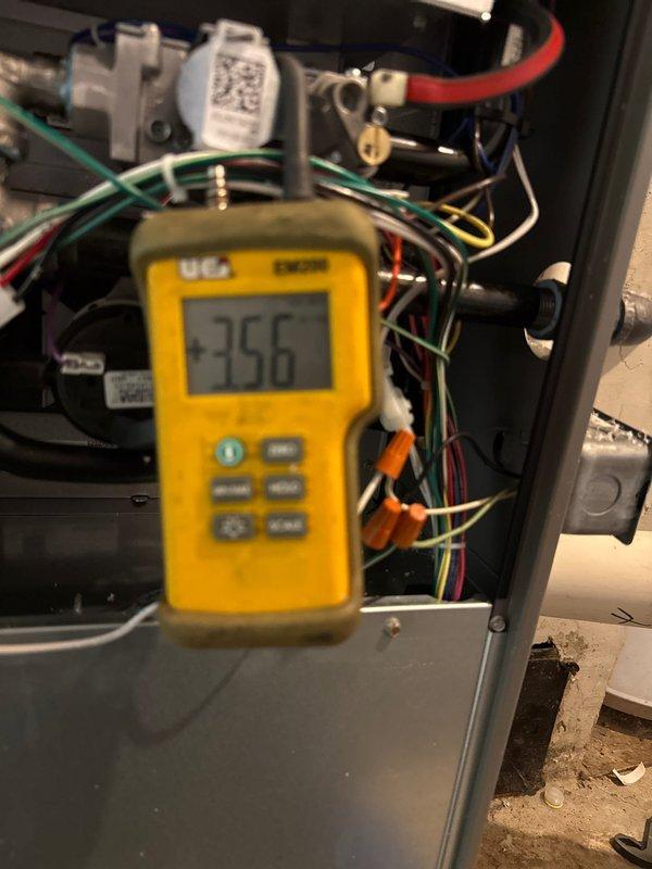 Completed installation of a 90% efficient furnace with humidifier. Properly installed condensate drainage system with P-trap assembly connected to PVC piping. Performed electrical testing with digital meter showing -356 reading to verify proper system function.