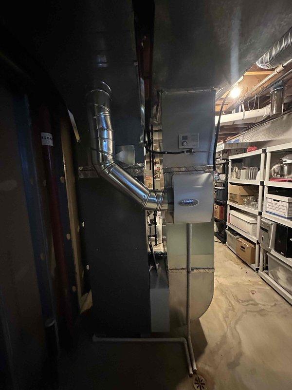 Successfully installed a complete Carrier HVAC system including a 90% efficient furnace, air conditioning unit, and humidifier in customer's basement. System features proper PVC venting with professional ductwork connections. All components were installed according to manufacturer specifications and tested for optimal performance.