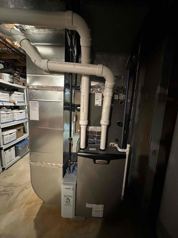 Successfully installed a complete Carrier HVAC system including a 90% efficient furnace, air conditioning unit, and humidifier in customer's basement. System features proper PVC venting with professional ductwork connections. All components were installed according to manufacturer specifications and tested for optimal performance.