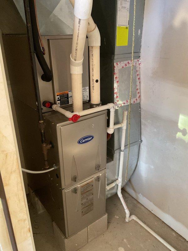 Performed scheduled maintenance service on Carrier furnace system (rolled from 11/19). Completed comprehensive heating system inspection including examination of PVC ventilation piping, valve connections, and ductwork. System appears to be in good working condition with proper installation and no visible damage.