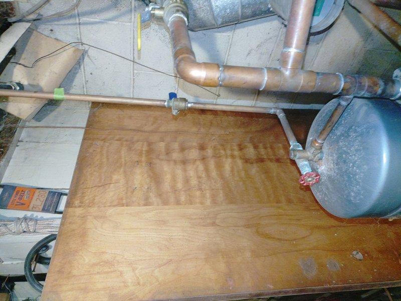 Performed diagnostic assessment on customer's oil furnace of undetermined age after receiving referral. Inspected plumbing connections and copper piping system in utility area, noting proper insulation on pipes and functionality of blue valve components. Examined expansion tank and verified integrity of ductwork connections to ensure optimal system operation.