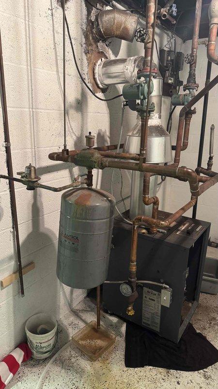 Diagnosed and repaired leaking boiler system with missing MVP valve. Inspected AMTROL expansion tank and associated copper piping network, finding evidence of corrosion at connection points. Replaced faulty pressure relief valve and restored proper system operation, eliminating leakage and ensuring safe combustion ventilation.