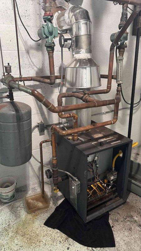 Diagnosed and repaired leaking boiler system with missing MVP valve. Inspected AMTROL expansion tank and associated copper piping network, finding evidence of corrosion at connection points. Replaced faulty pressure relief valve and restored proper system operation, eliminating leakage and ensuring safe combustion ventilation.