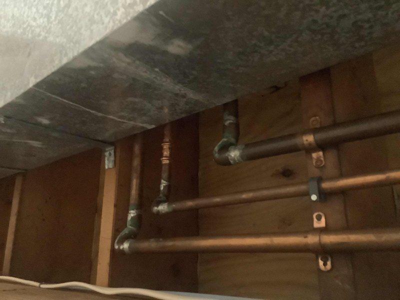 Responded to customer inquiry regarding master bathroom sink drain issue and leaky supply line in basement. Upon inspection, identified copper supply piping with multiple elbows and joints mounted to wooden framing that required repair. Addressed the drainage problem and replaced damaged section of supply line, securing all pipes with appropriate brackets to ensure proper function and prevent future leaks.