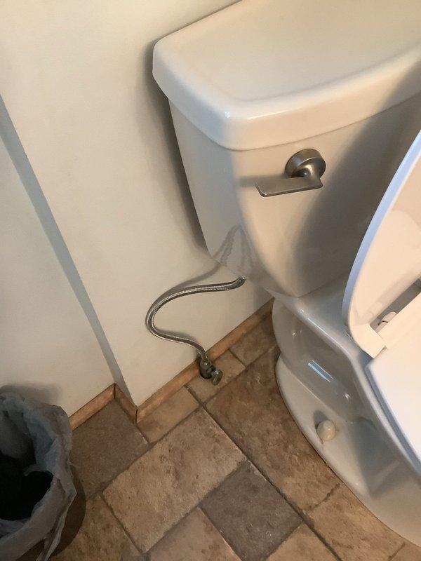 Responded to emergency service call for toilet water leak causing significant ceiling damage in kitchen below. Discovered water intrusion through bathroom floor from toilet connection. Repaired faulty water supply line and sealed connection to prevent further leakage. Advised customer that ceiling repairs would require separate drywall/restoration services.