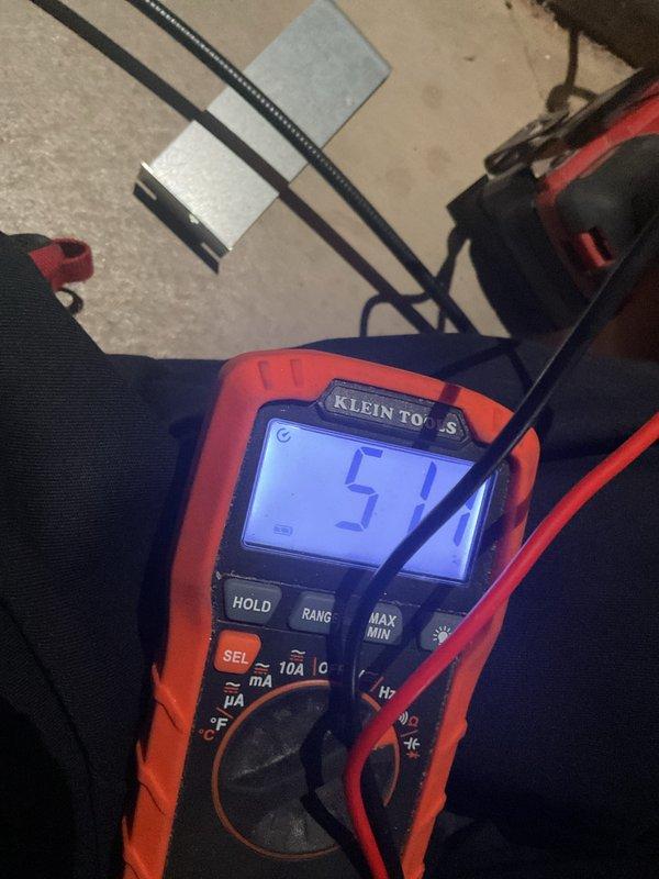 Responded to service call for furnace not heating. Performed diagnostic testing with multimeter, confirming voltage reading of 51V at control board. Accessed furnace compartment and adjusted flame sensor with hex tool to restore proper operation. System now functioning correctly with normal heat output.