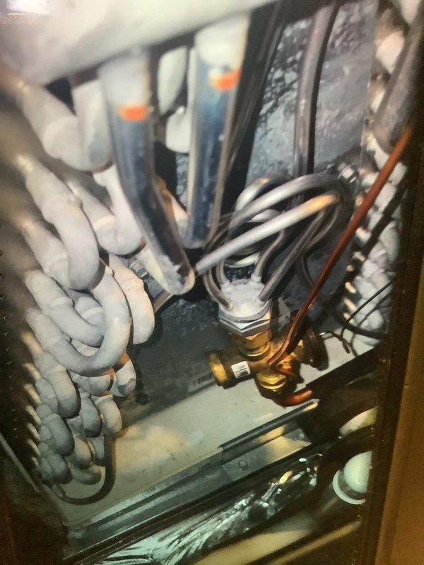 Performed MVP Heating Visit on 1-year-old system. Inspection revealed significant frost buildup on evaporator coils, indicating possible refrigerant issues or restricted airflow. Documented condition with photos and tagged system components for follow-up service.