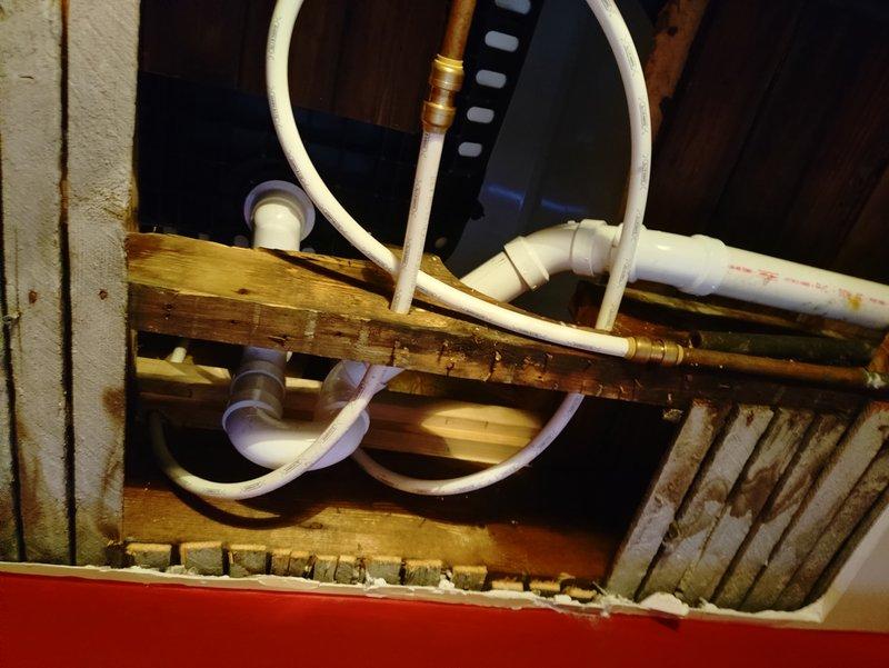 Successfully replumbed second floor tub drain line through first floor ceiling, installing a proper P-trap and new waste and overflow kit. Completed installation of PVC drainage components through ceiling joists with all required fittings and connections to ensure proper functionality.