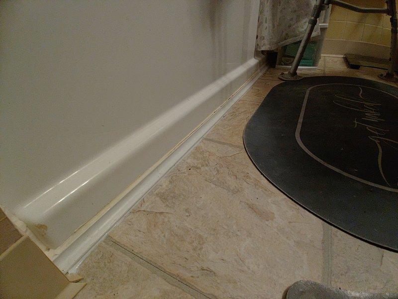 Successfully replumbed second floor tub drain line through first floor ceiling, installing a proper P-trap and new waste and overflow kit. Completed installation of PVC drainage components through ceiling joists with all required fittings and connections to ensure proper functionality.