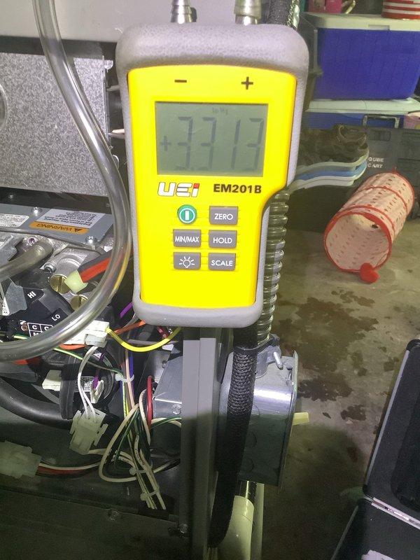 Performed routine MVP Furnace Visit on 4-year-old unit. Conducted visual inspection of heat exchanger components and coil surfaces, noting light dust accumulation. Completed diagnostic testing using UEI EM201B manometer to verify proper system pressure readings (3373), ensuring optimal heating performance and efficiency.