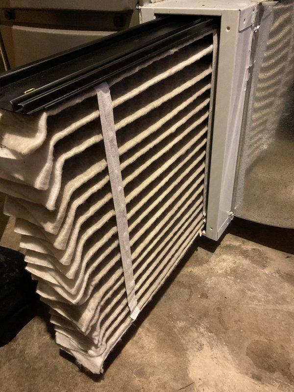 Performed MVP furnace maintenance service including inspection and documentation of existing air filters. Found current filters showing moderate dust accumulation but still in serviceable condition. Documented filter condition with photos for service record and future reference.