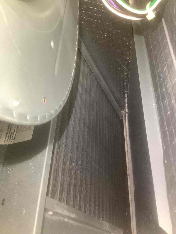 Completed furnace tune-up service on residential heating system. Inspected heat exchanger and cooling coil components for proper operation. Observed and documented condition of metal fins and internal components, noting no significant issues requiring immediate attention.