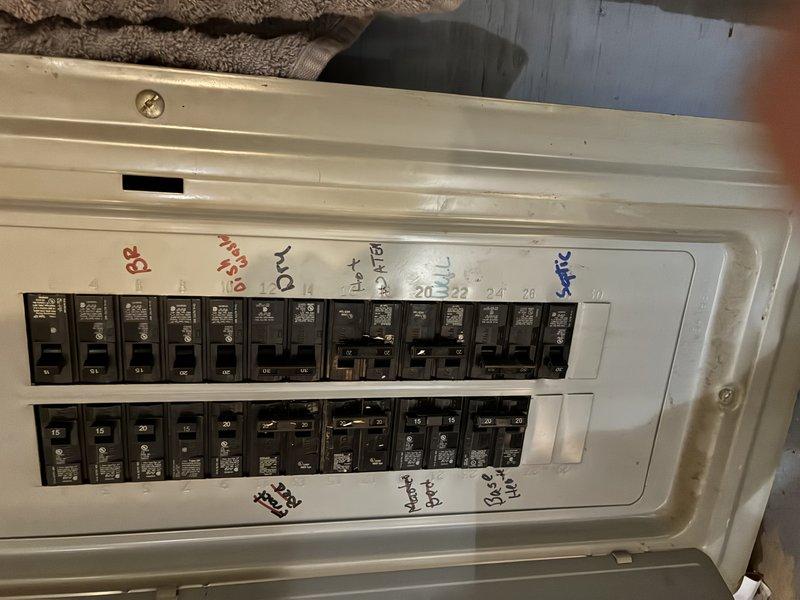 Serviced pressure switch on electrical panel system. Inspected 20-24 circuit breakers and verified all circuit identification labels. Ensured proper operation despite winter conditions and snow accumulation against exterior building wall.