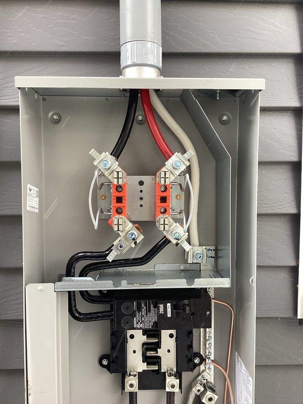 Completed 200A service upgrade with code-compliant exterior disconnect installation per 2023 NEC requirements. Installed new panel board and electrical kit with proper wiring connections and terminal assembly. All components were properly mounted and secured to exterior wall with appropriate conduit connections.