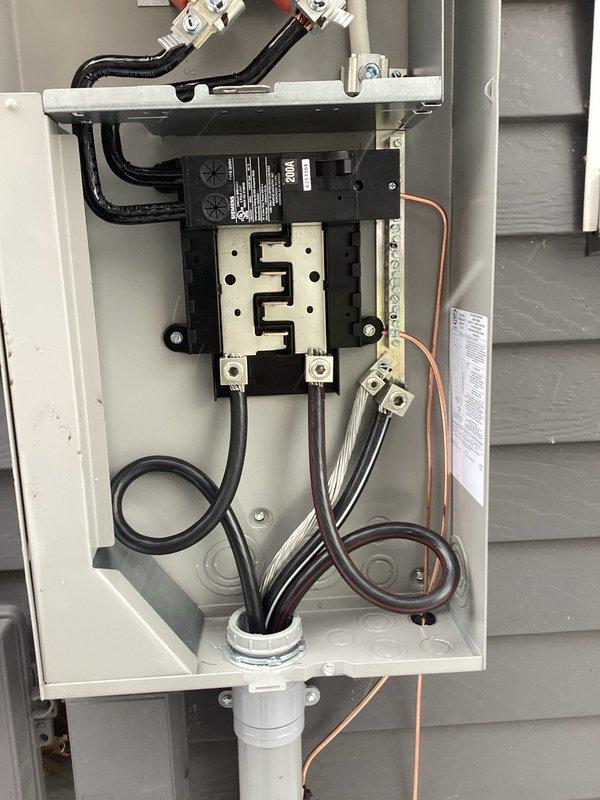 Completed 200A service upgrade with code-compliant exterior disconnect installation per 2023 NEC requirements. Installed new panel board and electrical kit with proper wiring connections and terminal assembly. All components were properly mounted and secured to exterior wall with appropriate conduit connections.