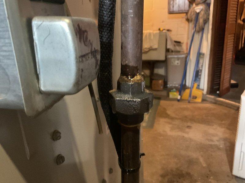 Performed routine maintenance on heating system that had been rescheduled due to weather. Inspected blower assembly which showed significant dust accumulation on squirrel cage fan blades. Examined plumbing connections and pipe fittings in utility area, noting condition of both insulated and metal piping components.