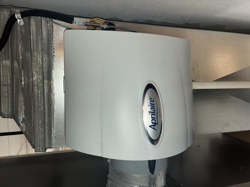 Completed furnace maintenance service as rescheduled. Inspected air filter which showed normal dust accumulation but remains functional. Examined Aprilaire whole-home humidifier system; verified proper installation with appropriate ductwork connections and sealing.