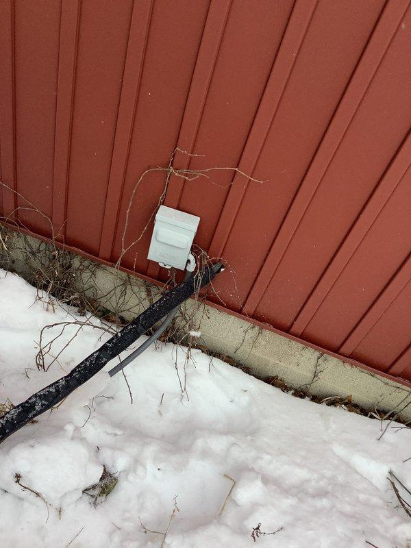 Diagnosed heat pump exhibiting poor heating performance and unusual operational noise. Recommended installation of outdoor temperature sensor to optimize system integration with customer's existing wood burner that shares ductwork. Documented current system condition with exterior unit photos showing snow accumulation and mounting location.