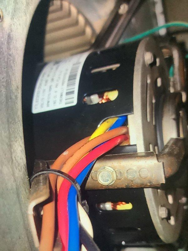 Performed annual heating maintenance on 12-year-old system. Inspected motor assembly and electrical connections, noting normal wear on brass fittings. Examined evaporator coil assembly and refrigerant lines, observing some frost/dust accumulation on the coil surfaces. System operational and functioning within normal parameters.