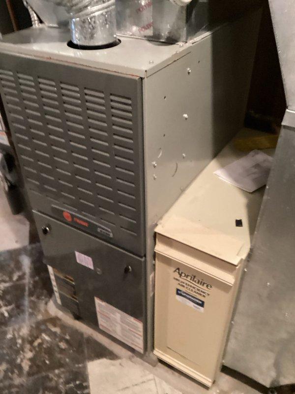 Performed scheduled heating maintenance visit that was previously owed to customer. Inspected furnace system with attached Aprilaire humidifier and noted significant corrosion on copper elbow joint connecting to PVC pipe, showing signs of leakage and mineral buildup. Recommended repair of deteriorated connection to prevent future water damage and ensure proper system operation.