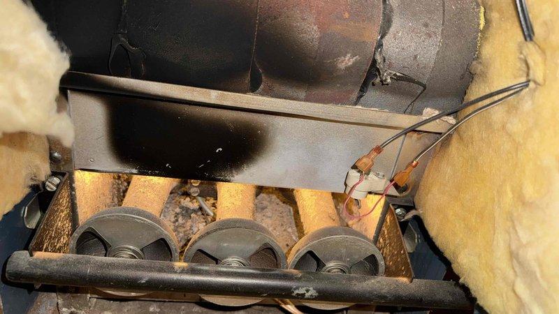 Responded to customer complaint of gas odor. Inspection revealed severely corroded copper water valve with significant oxidation and verdigris formation. Examined furnace interior, noting heat-damaged metal components, discolored ductwork, and accumulated debris around blower wheels with possible electrical connection issues.