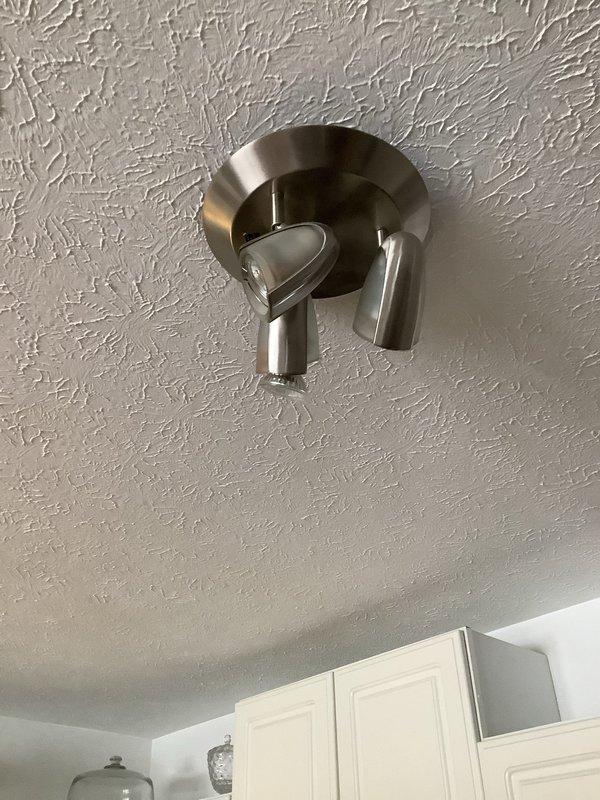 Responded to a water leak service request for a 25-year-old home. Investigated water intrusion between floors, focusing on bathroom plumbing fixtures. Identified mineral buildup around sink drain as potential contributing factor. Performed necessary repairs to stop leak transmission from upper to lower level, preventing further damage to ceiling-mounted light fixture in the kitchen area below.