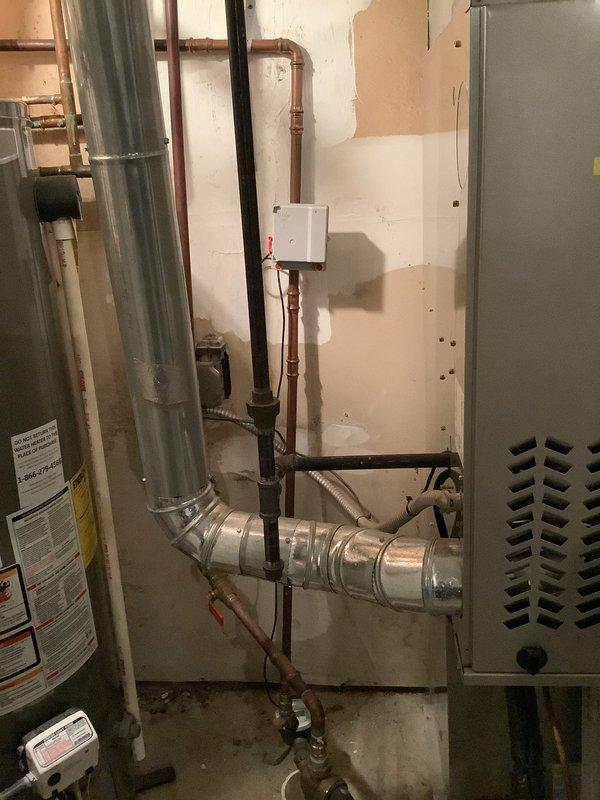 Responded to service call for frozen pipes causing complete water outage in the home. Inspected the water heater (Lochinmar model) and plumbing system in the utility area. Provided customer with professional guidance on safely thawing frozen pipes and proper procedure for restoring water service to prevent potential pipe damage and future freezing issues.