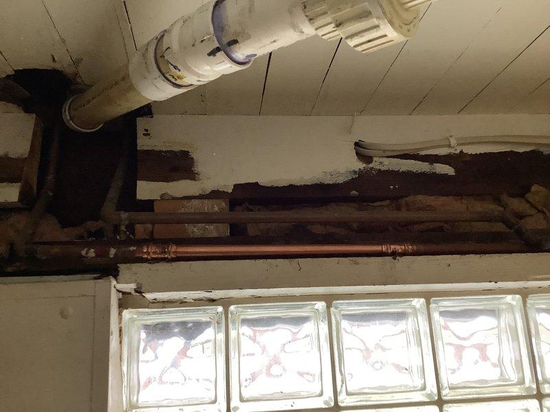 Responded to emergency call for burst copper pipe in basement causing complete loss of water service to home. Located split in aged copper supply line adjacent to previous installation work. Replaced damaged section with new copper piping, restored water service, and verified proper pressure throughout system. Assisted with initial water removal from affected basement area.